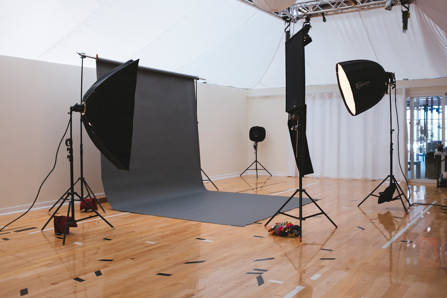 Professional photo studio with softboxes and paper backdrop.