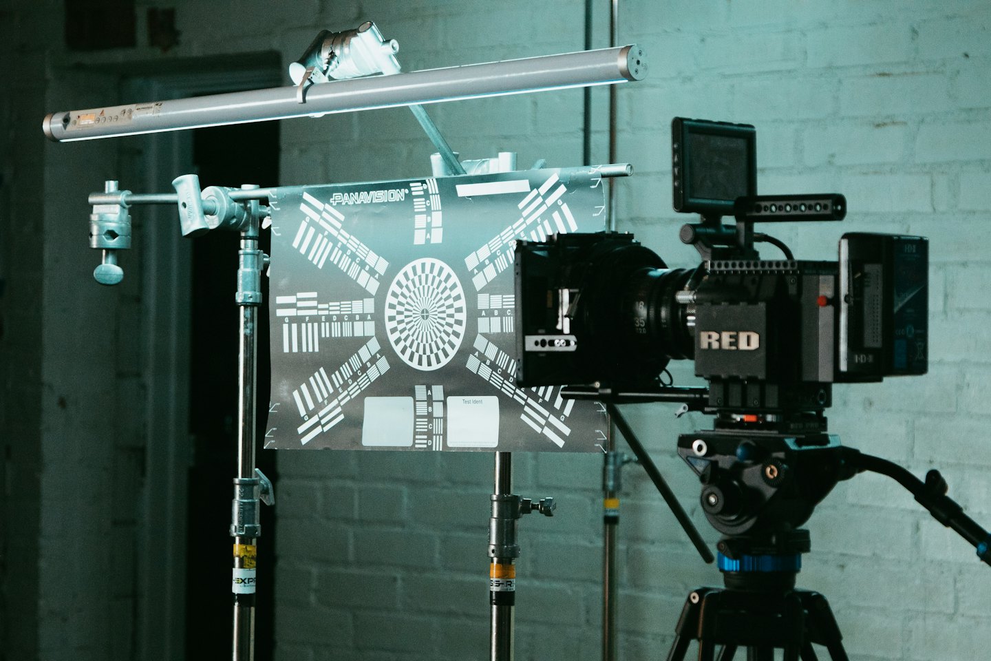 Cinema camera on a tripod filming a test chart.